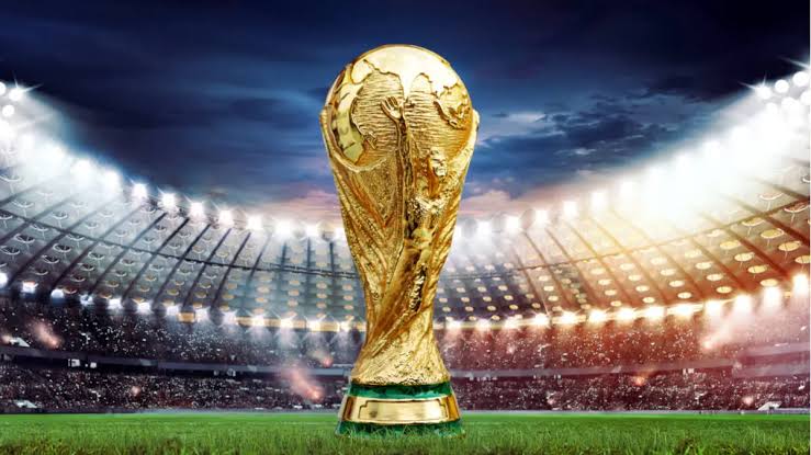 The World Cup trophy under stadium lights